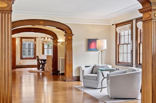 This welcoming sitting room with rich architectural details create a timeless ambiance, while natural light floods the space and highlighting its charm.