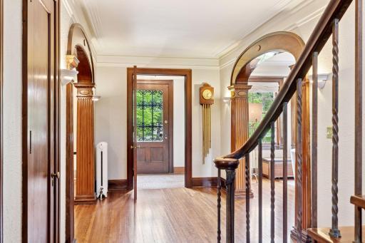 The elegant foyer showcases a solid wood entrance door with intricate wrought iron glass inserts, flanked by matching solid wood door frames!