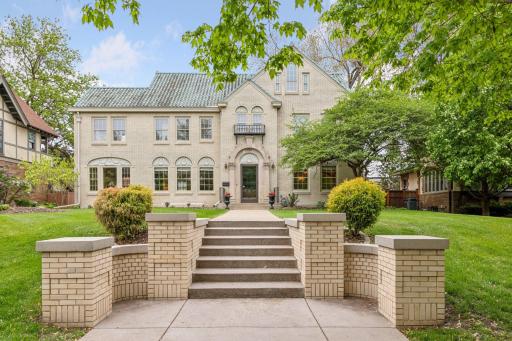 The grand entry steps feature wide cement treads flanked by stately brick walls with pillar-like caps, contributing to the home's amazing curb appeal!