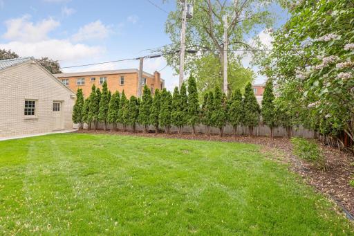 The beautifully landscaped backyard offers a serene and private sanctuary.