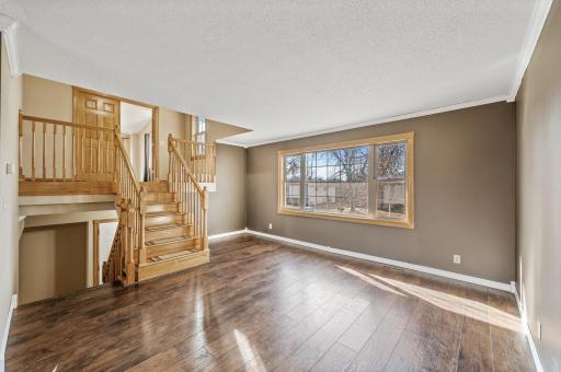 Living room, stairs that lead up to the private & massive primary suite.