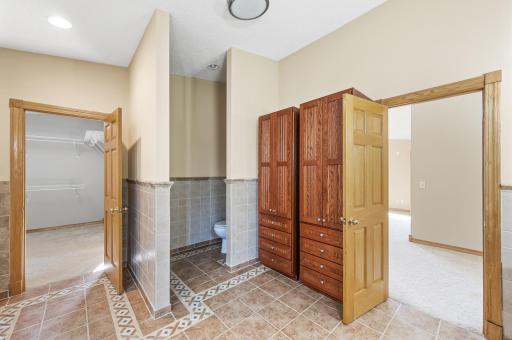Primary bathroom featuring dual sinks, a tile shower, and a soaking tub.