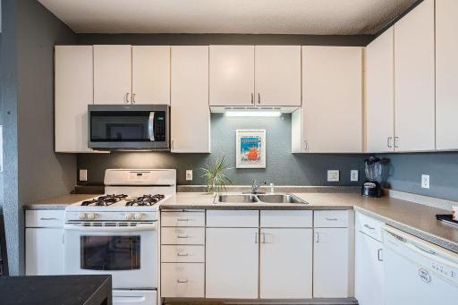 A well-equipped kitchen with generous cabinet storage and counter space.