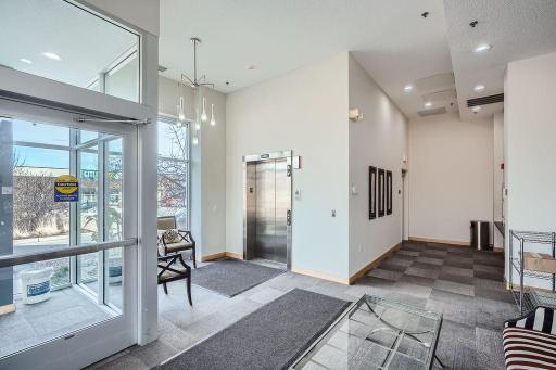 Welcoming front lobby, secure entry, elevator, mailboxes, and package delivery.