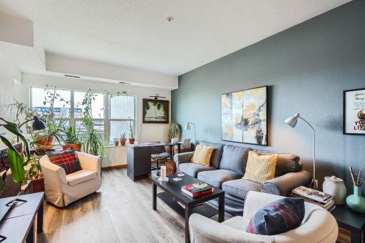 A light-filled and welcoming living room. Open floor plan including the dining area and kitchen.