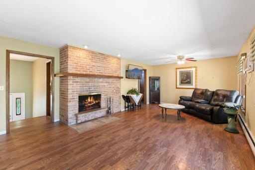 Here's another look at the main floor living room/dining room. The fireplace is the focal point and the beautiful brick adds such a classic look!