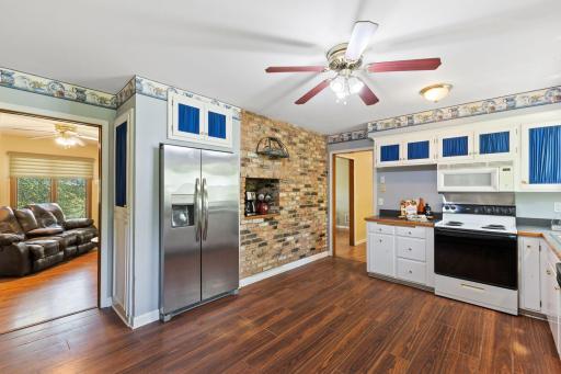 The kitchen is the heart of the home and this one is HUGE! Tons of cabinetry and counter-space for all of the baking, cooking and creating you could think of! The exposed brick wall offers a space for an indoor grill (the owners have never used it)