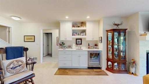 Gorgous wet bar with quartz countertops and beverage fridge