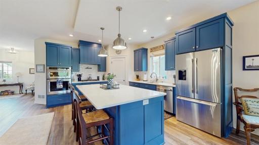 Stunning kitchen features stainless steel appliances and quartz countertops