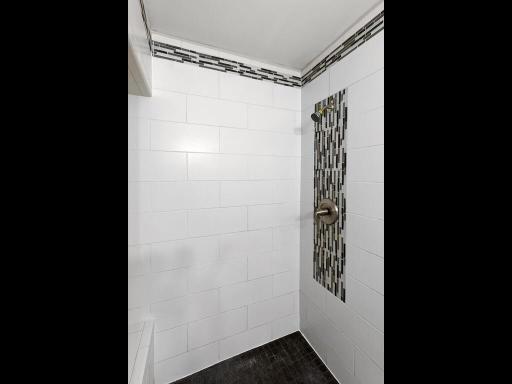 A decorative tile design adds character and visual interest to this shower.