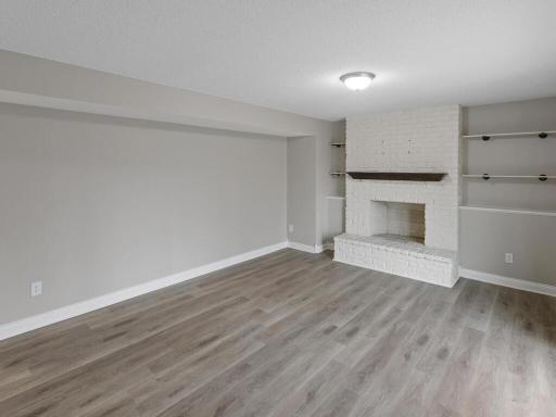 The lower level family room has a stylish wood burning fireplace with stylish wood mantle and new maintenance free flooring.