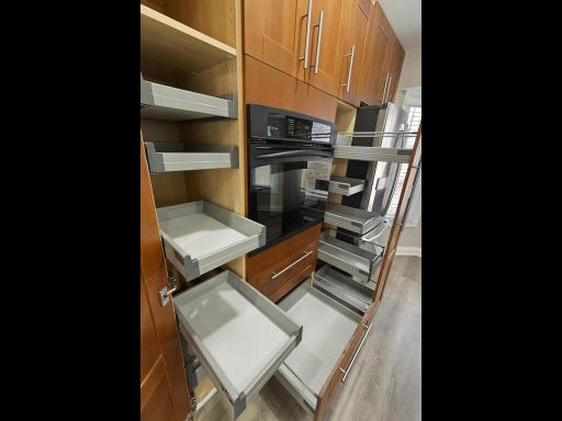 Pull-out shelving throughout the kitchen provides smart, accessible storage for effortless organization.