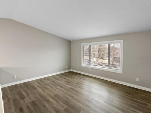 This view of the living room captures the inviting atmosphere and generous space.