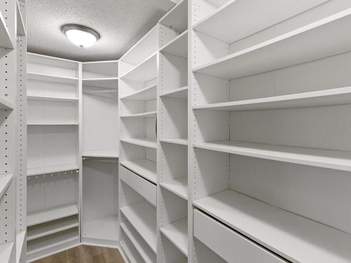 The primary bedroom also features an extensive built-in storage system offering ample storage and organization
