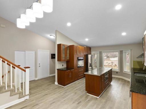 From the dining room, enjoy a clear view of the homes layout, seamlessly connecting the entry to the kitchen and both stairways.