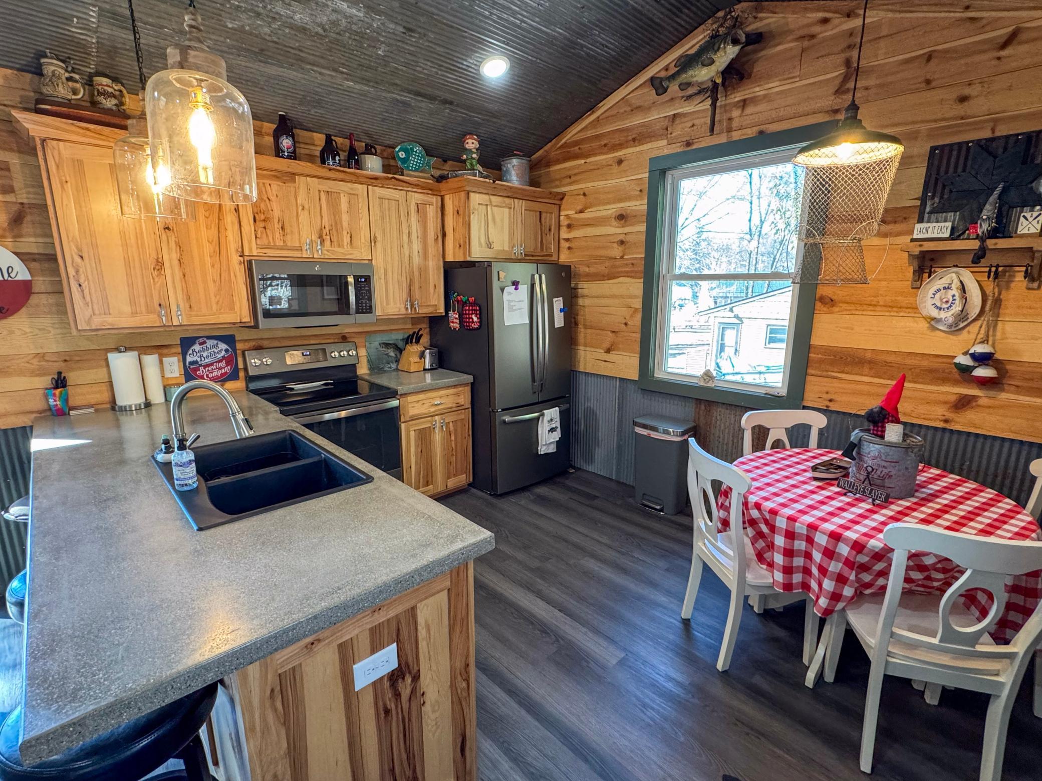 Kitchen with stainless steel appliances and concrete countertops