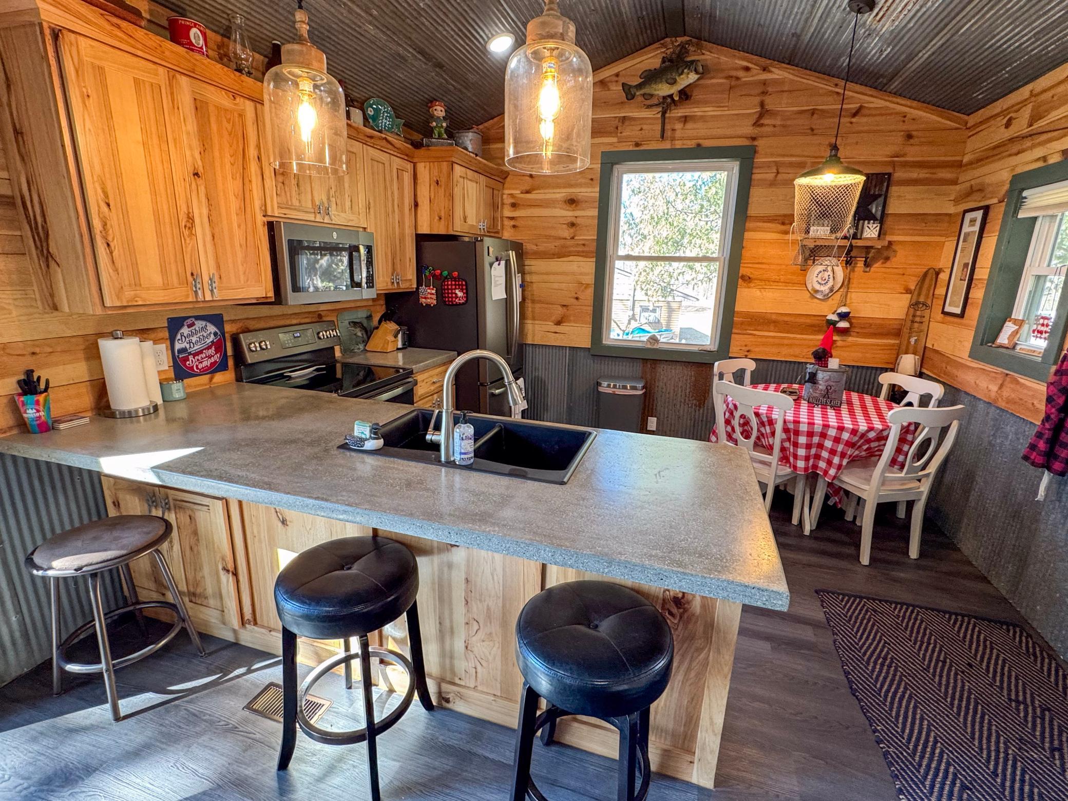 Kitchen with stainless steel appliances and concrete countertops