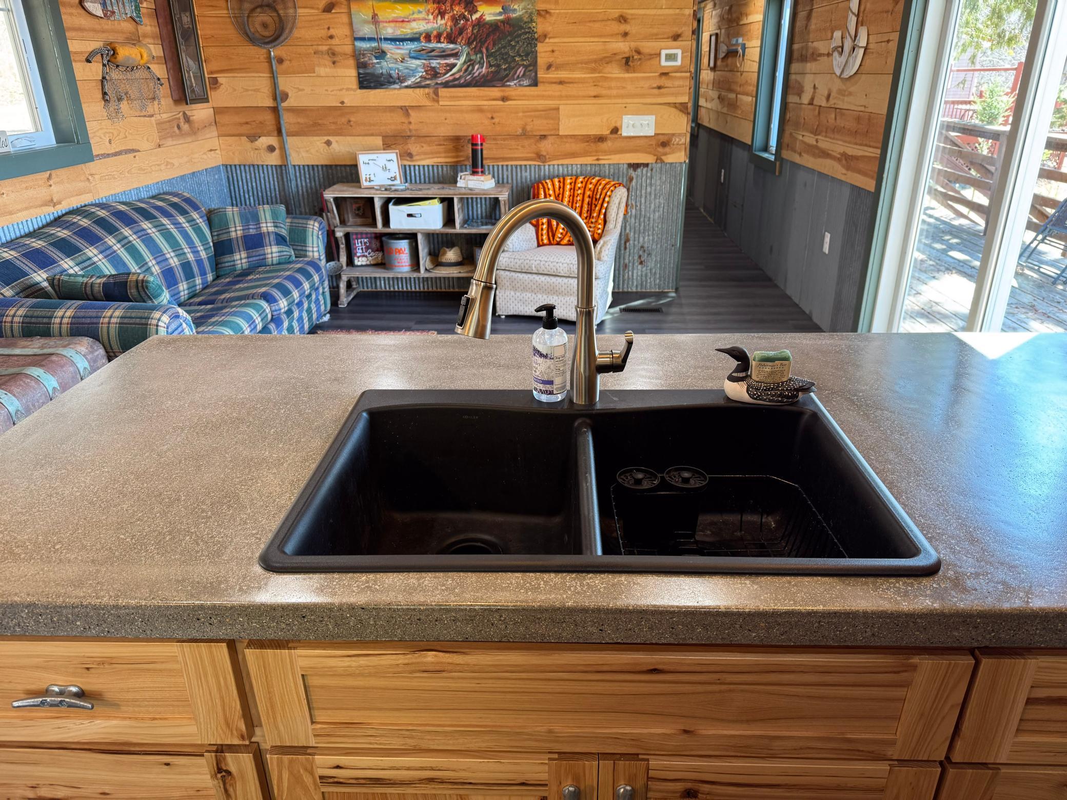 Kitchen with stainless steel appliances and concrete countertops