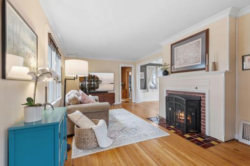 A beautiful blend of comfort and charm, this living room showcases a gas fireplace with a rich tile hearth and mantle, plus seamless flow into the dining areaâperfect for cozy evenings and gatherings.