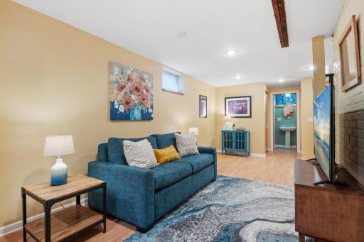 The spacious lower-level family area is both functional and inviting, featuring recessed lighting, warm tones, and ample space for relaxing, entertaining, or even transforming into a private ownerâs suite.