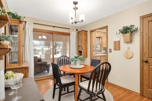 Formal dining room with hardwood floors and sliding door to 4-season porch