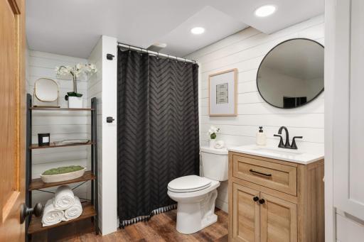 Lower Level Newly finished 3/4 Bathroom with Shiplap Walls and Matte Black Hardware