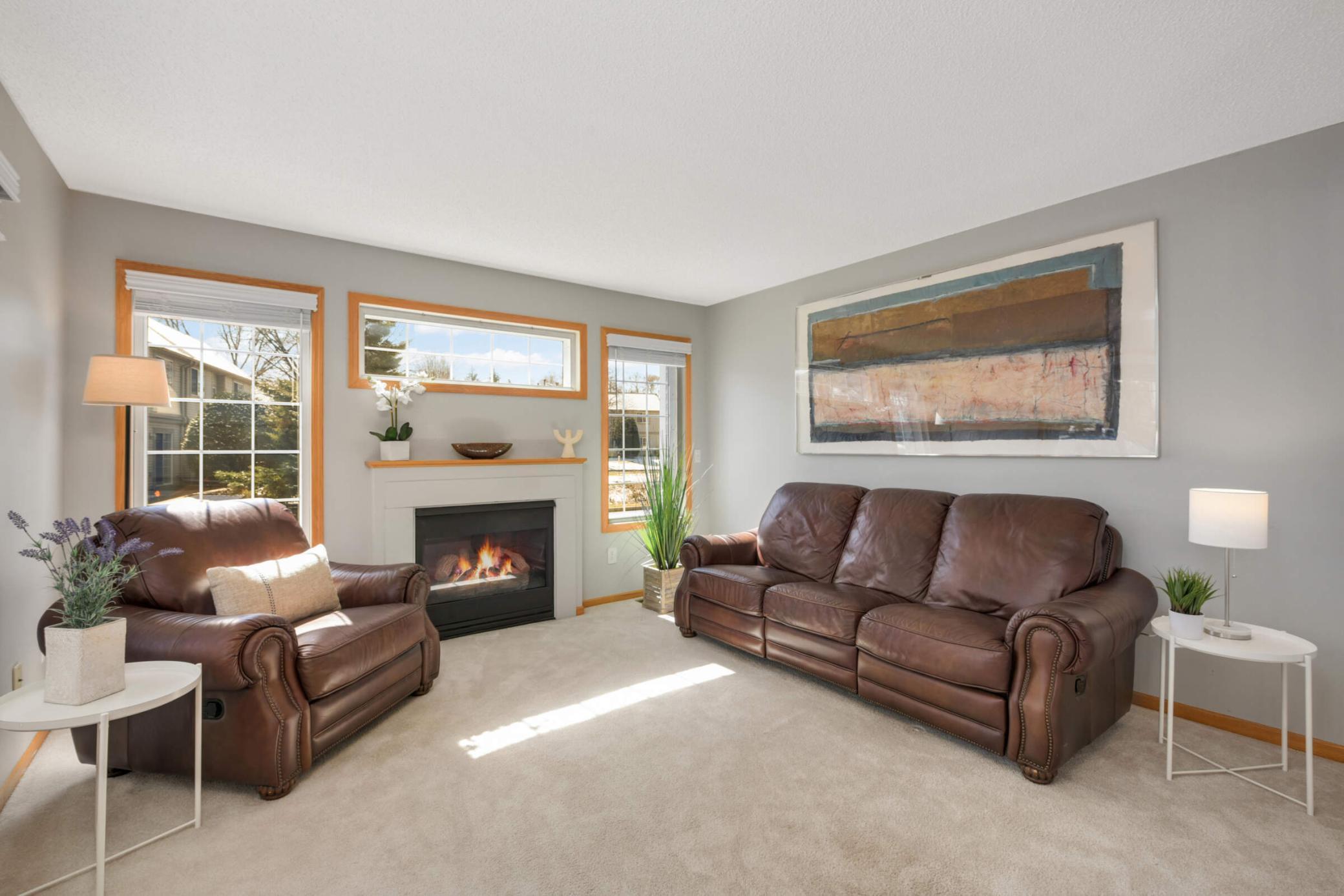 LOVELY living room has TONS OF NATURAL LIGHT! COZY GAS FIREPLACE!!