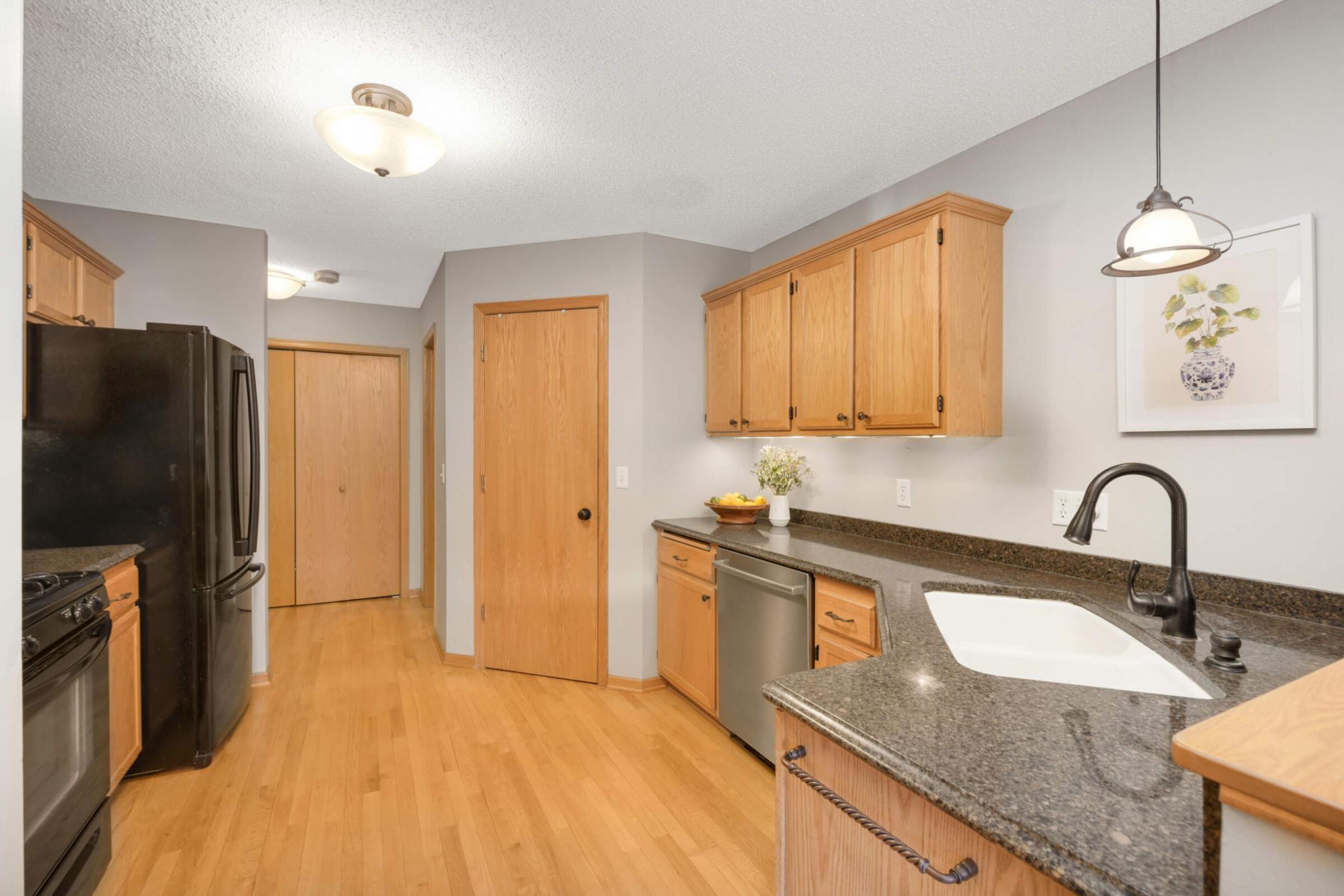 Impressive kitchen features nice Cambria countertops, great pantry, hardwood floors, nice bathroom!