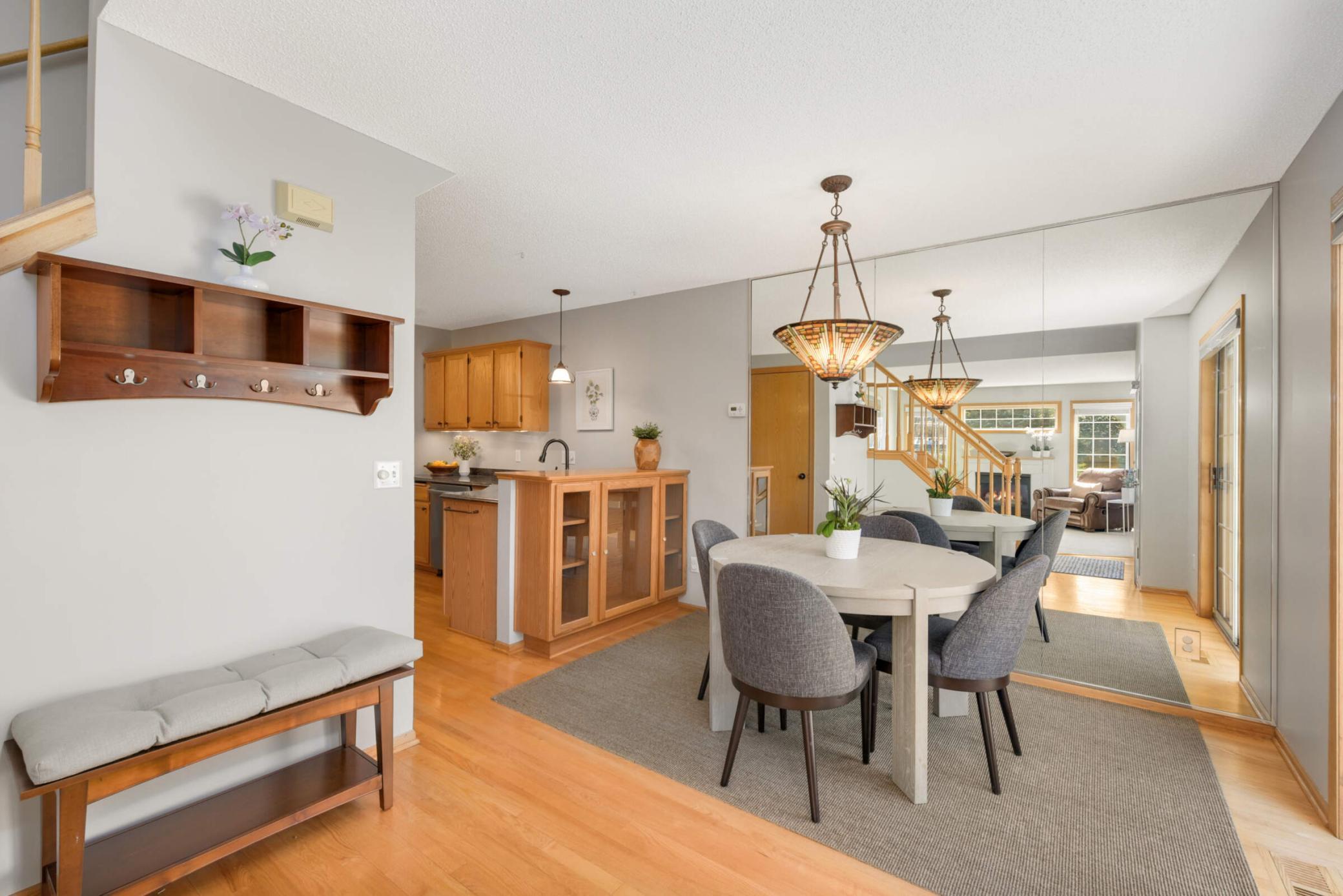 Dining area features a beautiful TIFFANY CHANDELIER, built in cabinetry and hardwood floors.