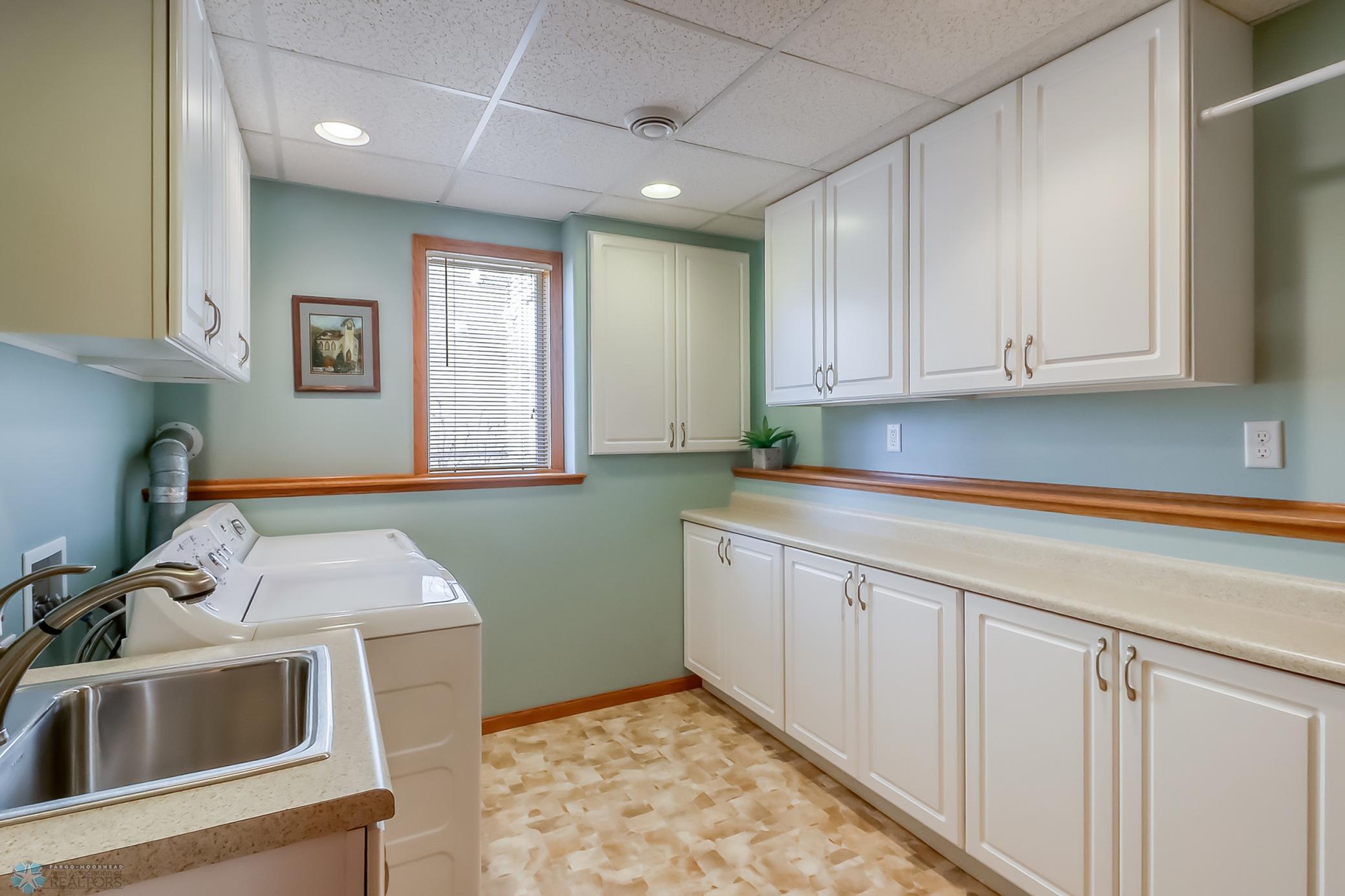 Fully finished laundry room with storage