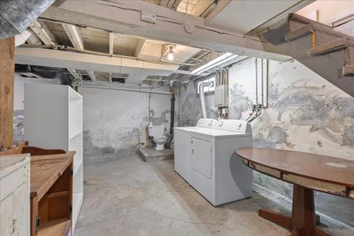 Unfinished basement with laundry and bathroom