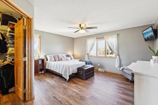 The main level primary bedroom is spacious! Large bed and furniture? No problem! More gorgeous wood flooring here to love!
