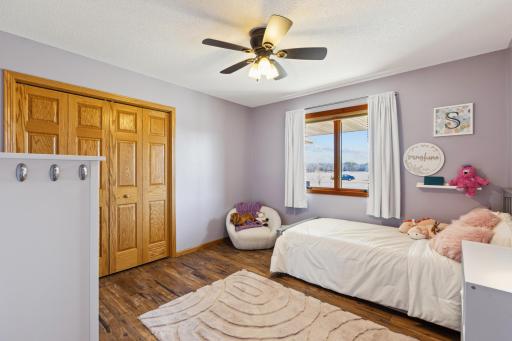 The 2nd bedroom on the main level is cozy with the wonderful paint color, cool flooring and nice sized closet! Perfect!