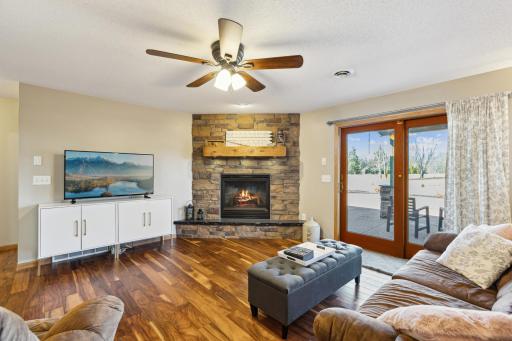 The lower level family room is a gem! From the stunning fireplace and mantel to the pretty floors to the walkout to the backyard, this room has it all!