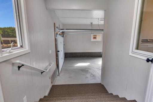 The mudroom leads to double-wide stairs into the attached garage