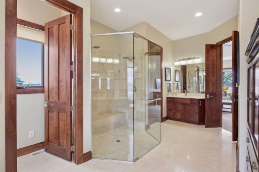 Primary bath features separate toilet rooms and separate vanities.