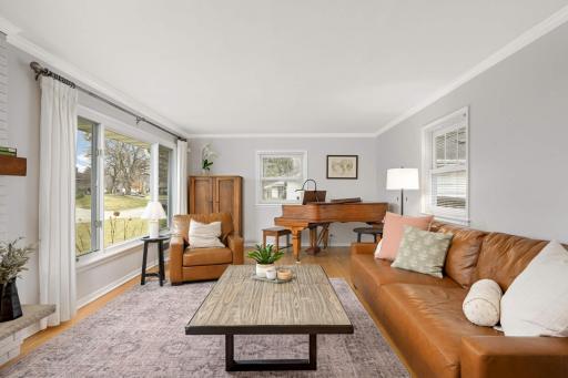 This spaciuos great room has hardwood floors and crown molding