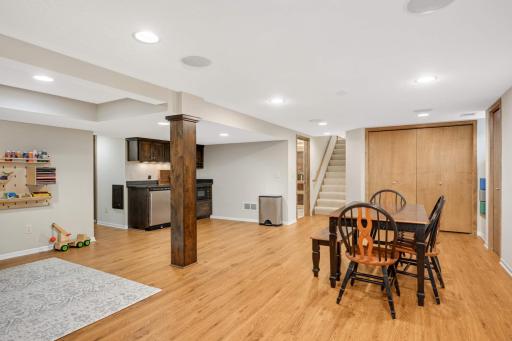 An open staircase flows to the beautifully finished lower level