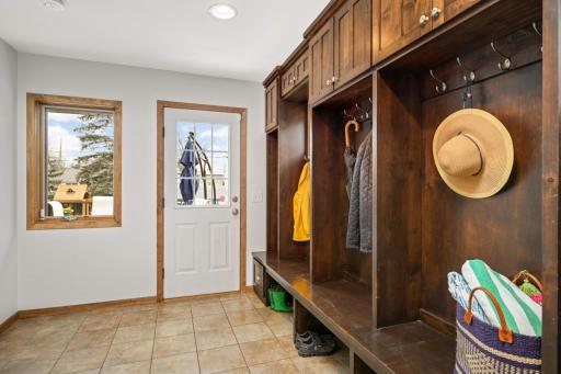An unbelivable mudroom is loaded with staorage and accesses the deck and finished double garage