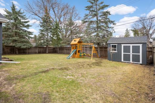 Great fenced backyard with a deck and shortage shed
