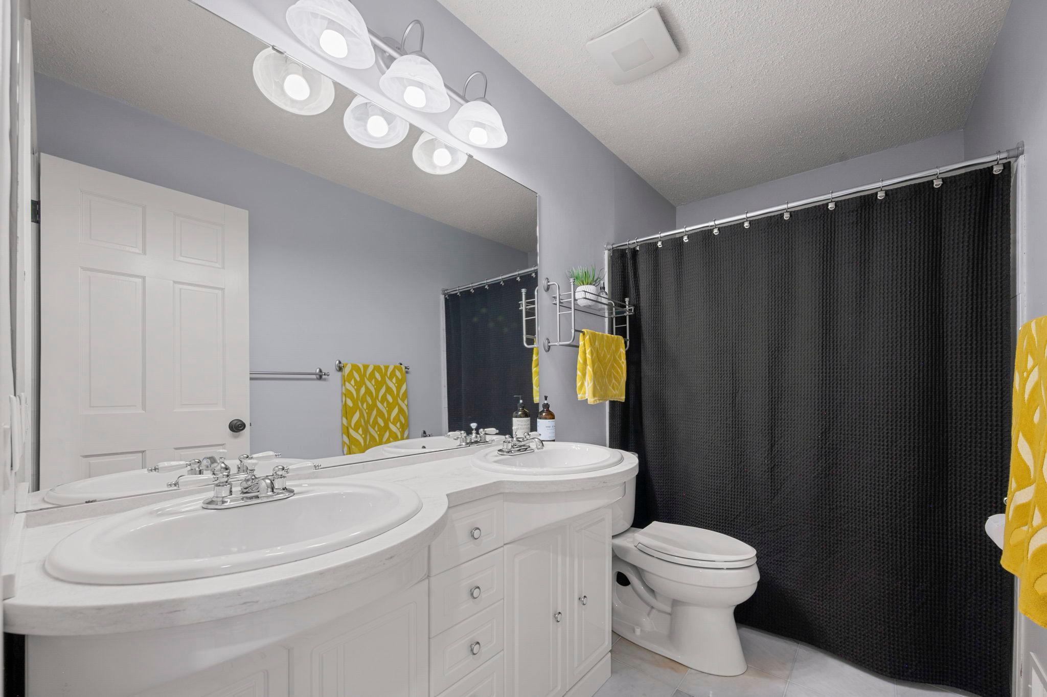 Full Bath has new bath fan and toilet, quartz counters, 2 sinks, tiled floor and shower/tub is jetted, new showerhead as well!