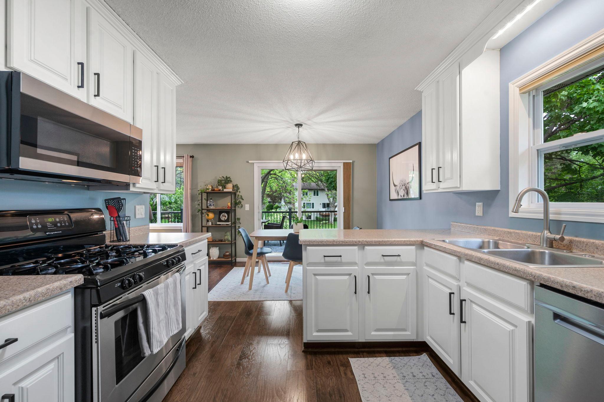 Kitchen is bright and aesthetically pleasing with a lovely kitchen window! This area is great for entertaining!
