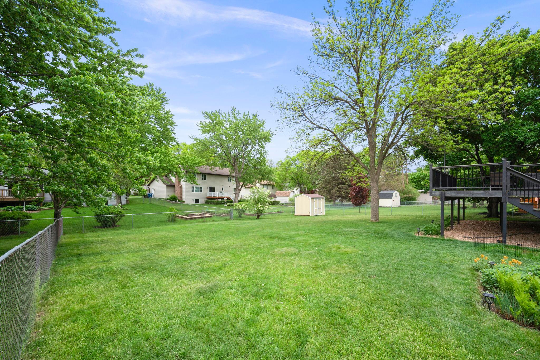 Yard is fenced in and beautiful with a shed that stays.
