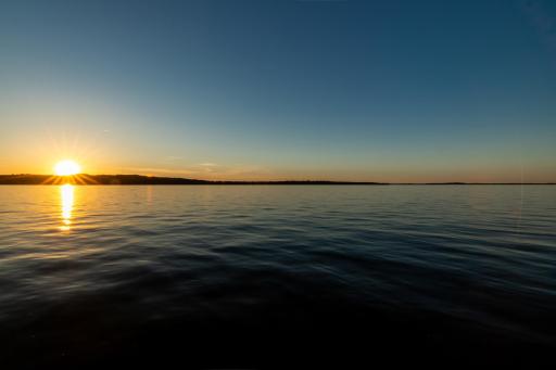 Open lake view during golden hour with tranquil water.