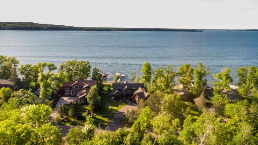 Aerial view of lakeside homes nestled along the shoreline with wooded privacy.