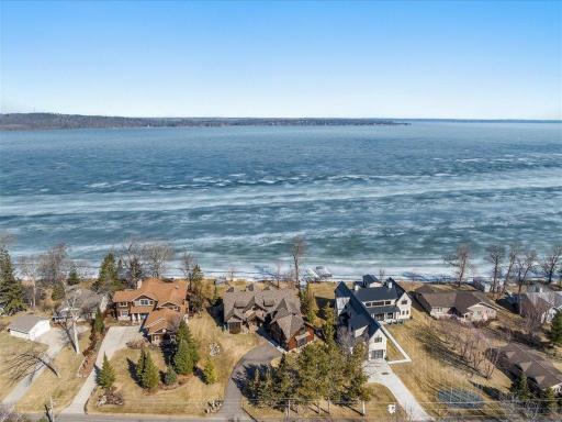 Expansive aerial showcasing shoreline, neighborhood, and surrounding lake views.