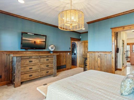 Primary suite with cozy lounge area, built-in dresser, and tranquil views.