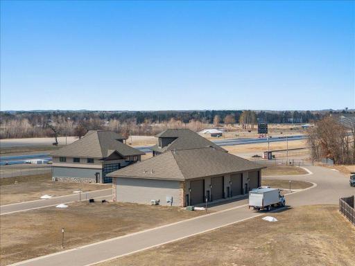 Wider aerial view of garage/shop and surrounding facilities.