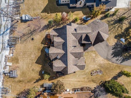 Aerial view of full property layout including main home, driveway, and surrounding grounds.