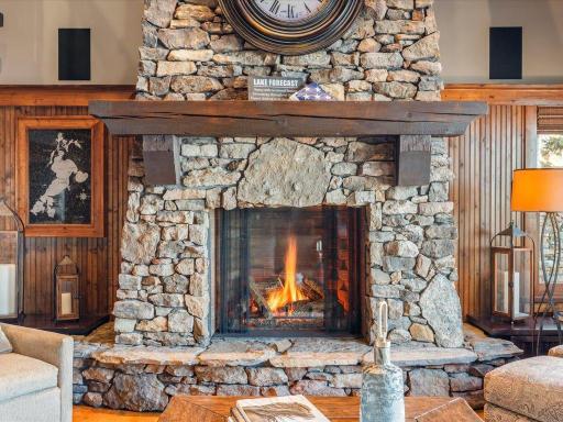 Custom floor-to-ceiling stone fireplace with timber mantel—anchoring the great room with warmth and rustic charm.